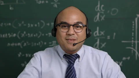  young teacher man looking at camera sitting teaching online video conference li Stock Footage 153507287