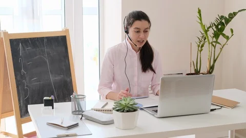 Young teacher teaching remotely and have lesson online from home.  Stock Footage 128979245