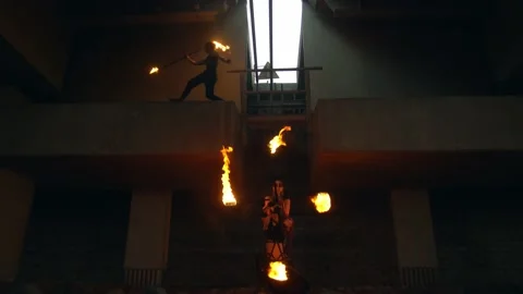 Young team with burning staff doing fire show on concrete background under road Stock-Footage 194377267
