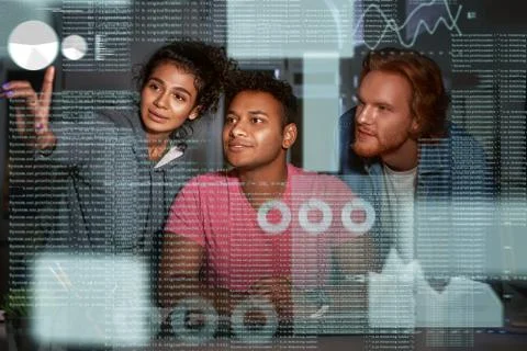 Young team of data analysts are going through endless data streams Foto stock