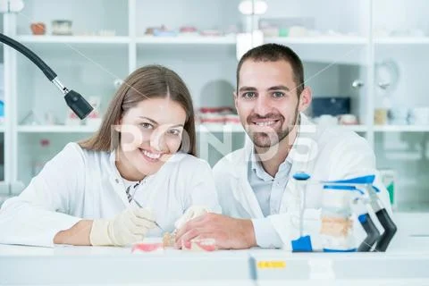 Young team of dental technicians making teeth prostetics. Process of making d Stock Photos