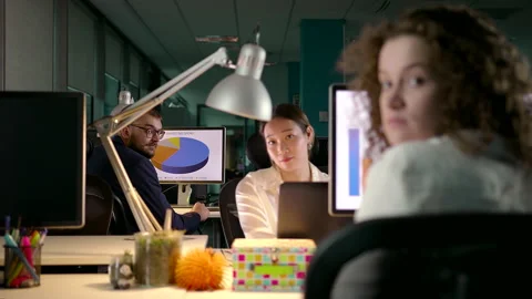 Young Team of Diverse Professionals Working Late in Modern Office Stock Footage 143698168
