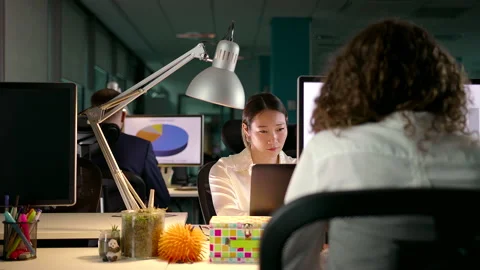 Young Team of Diverse Professionals Working Late in Modern Office Stock Footage 143699034