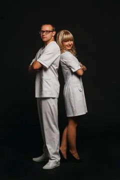 Young team of doctors standing back  folded isolated on lack Stock Photos