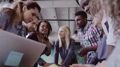 Young team working on new project. Group of mixed race people standing near the Stock Footage 84453485