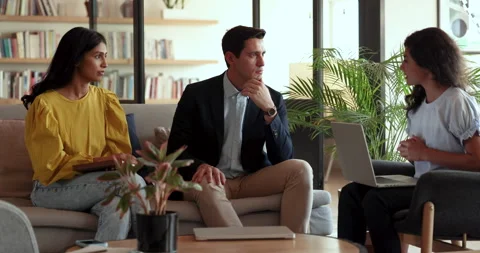 Young teammates discuss joint project in modern coworking office Stock Footage 260591244