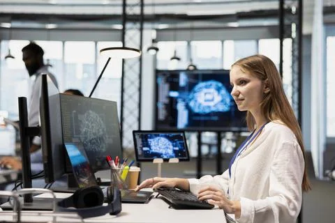 Young tech startup admin in office integrating AI machine learning systems Foto stock