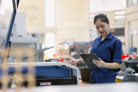 Young technician engineer worker with Metal Laser cutting machine in modern.. Stock Photos