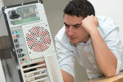 Young technician have a problem with computer 스톡 사진
