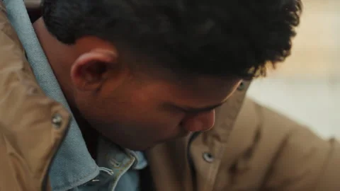 Young technician troubleshooting car issues at scrapyard. Male youth carefully Stock Footage 332506159