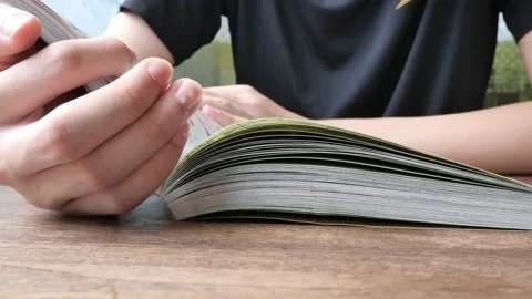 Young teenage boy read comic book at library. Stock Footage 135948477