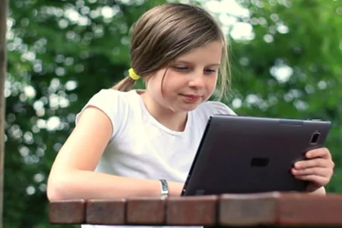 Young teenage girl with tablet computer outdoors, dolly shot NTSC Stock Footage