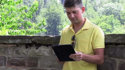 A young teenager with a tablet computer chatting. 動画素材 112026082
