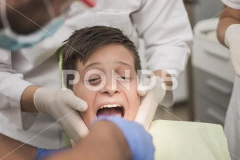 Young teenager is terrified at the dentist Stock Photos