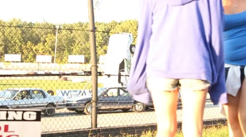 Young teens settle down in front of racetrack Stock Footage 8659841