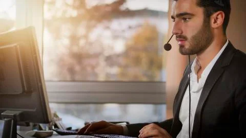 Young telemarketer, help desk assistant or customer service worker Stock Photos