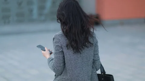 Young tender business lady in strict jacket with dark-brown hair walking on the Stock Footage