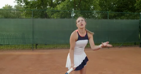Young tennis player missing the ball with disappointed expression handheld Stock Footage 158197613