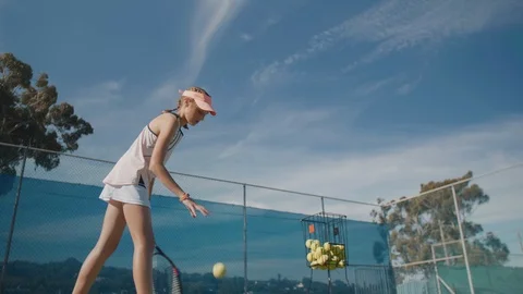 Young tennis player practising her serve Stock Footage 85648278