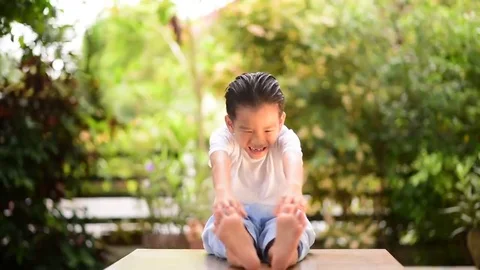 Young Thai boy practicing yoga in the park Stock-Footage 69217057