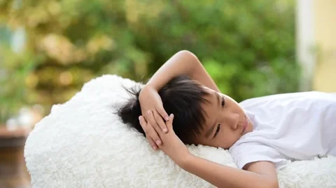 Young Thai boy sleep on the white bed 库存影片 68809567