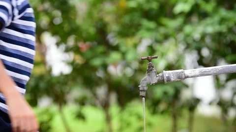 Young Thai boy take close the old faucet in the garden to safe water. Earth day  Stock Footage 66420969