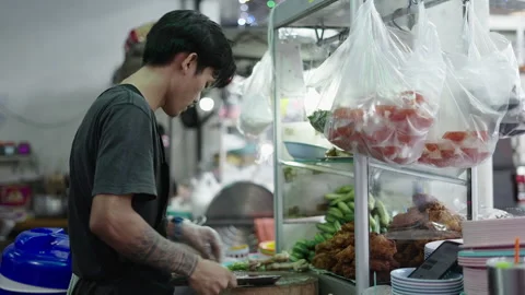Young thai cook cleaning table and knife after cut a chicken Stock Footage 232327690