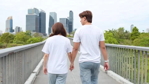 Young Thai Couple Holding Hands and Walking on Park Bridge Stock Footage 335505073