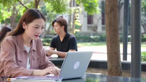 Young Thai Female Student Using Laptop Outdoors on University Campus 库存影片 329461668