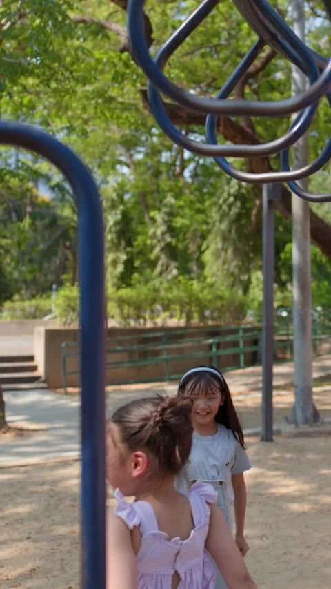 Young Thai Girl Playing on Monkey Bars at Lumpini Park Playground Stock Footage 334355713