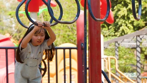 Young Thai Girl Playing on Monkey Bars at Lumpini Park Stock Footage 342583603