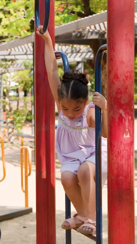 Young Thai Girl Playing on Monkey Bars at Lumpini Park Stock Footage 342583926