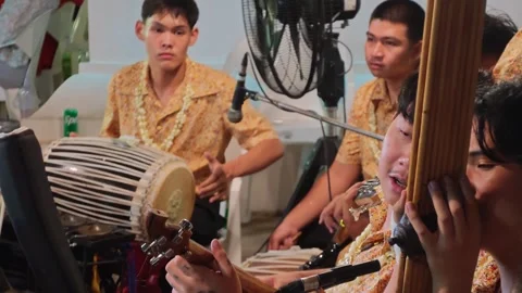 Young Thai musicians playing khlui flute saw duang and thon drum close up Stock Footage 337042709