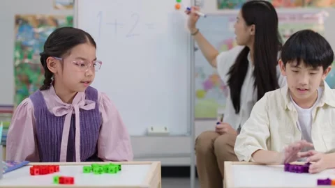 Young Thai Students Learning Math with Blocks in Elementary Classroom Stock Footage 328208636
