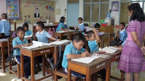 Young Thai students studying together at classroom teacher check their note book Stock Footage 157059979