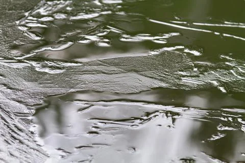Young thin ice covered the river after freezing Stock Photos