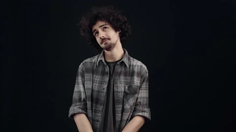 The young thinker, looking ahead, walks his eyes to and fro and then displays a Stock Footage 152657583