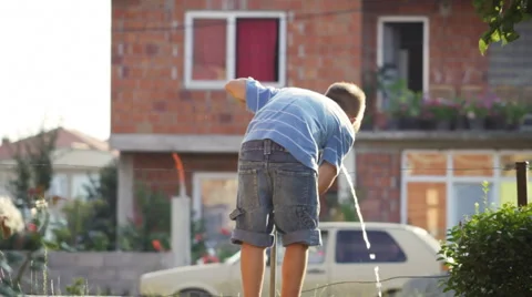 Young thirsty boy drinking water from a tap after football game Stock Footage 41530057