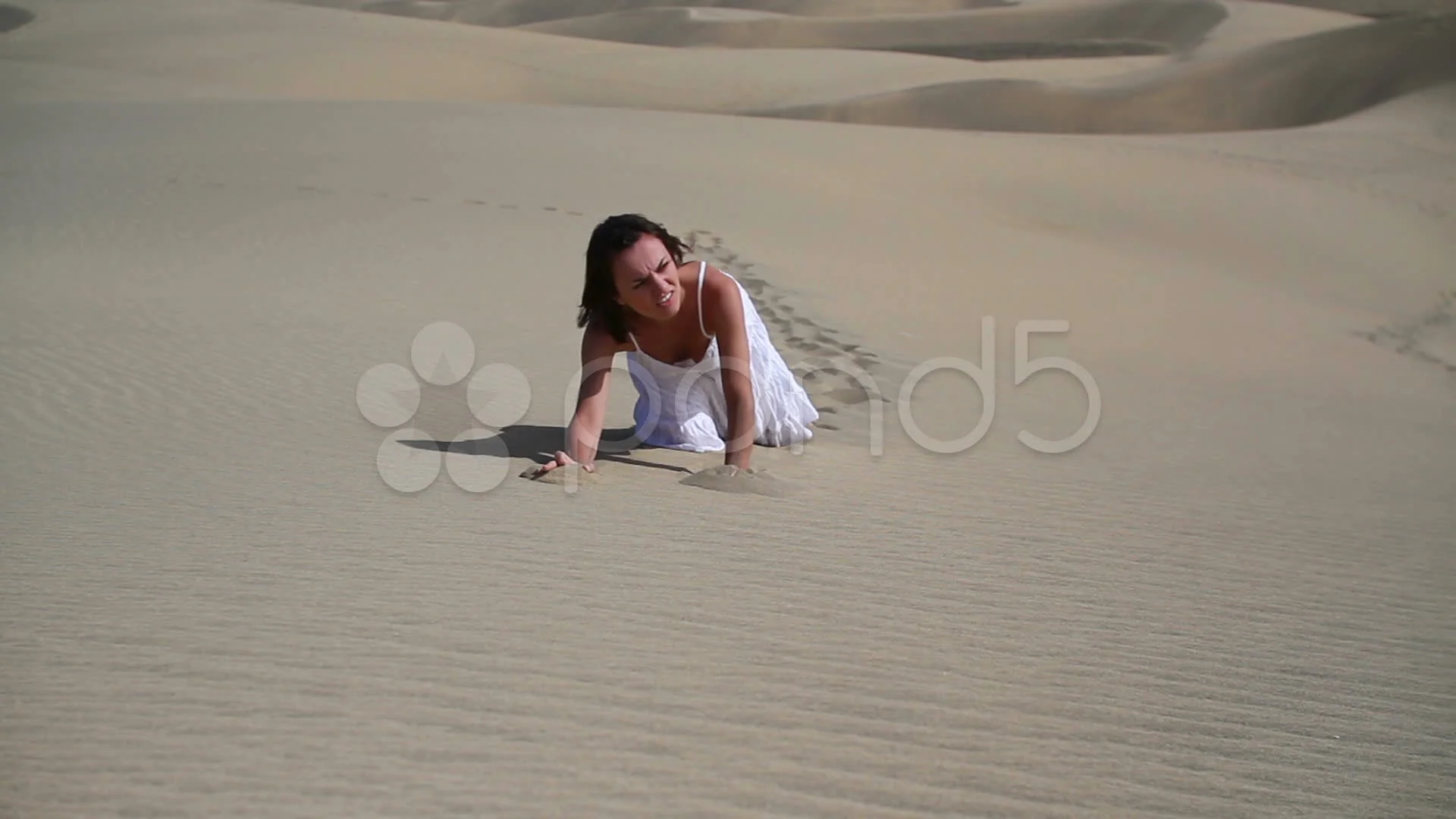 Young thirsty woman crawling in sand HD | Stock Video | Pond5