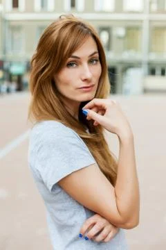 Young thoughtfull redhead model walking around city Stock Photos