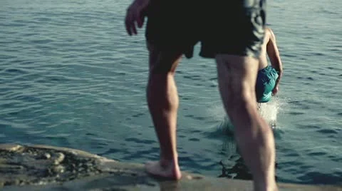 Young three men jumping into the sea, slow motion shot at 240fps Stock-Footage 22033500