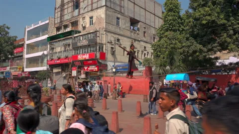 Young tightrope walker performing on a high wire in Old Delhi Stock Footage 340270638