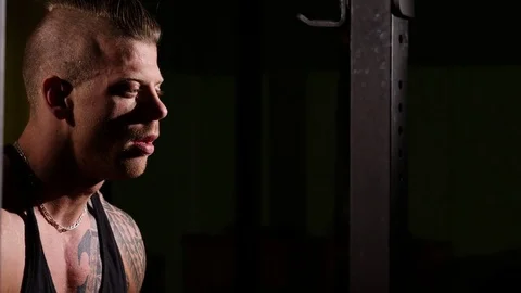 Young tired bodybuilder in a gym drinking from a shaker. 60 to 24fps 4K Stock Footage 74340179