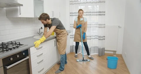 Young Tired Couple Cleaning Kitchen 動画素材 119777516