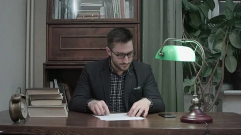 Young tired professor having a break to talk on the phone Видео 73686206