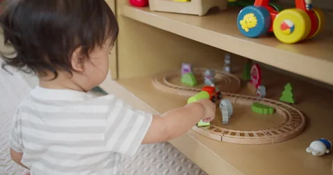 Young toddler develops fine motor skills through imaginative play 動画素材 334220958