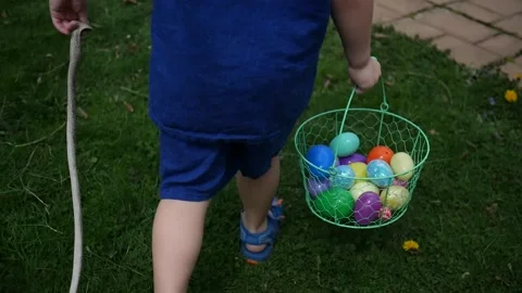 Young Toddler hunting for Easter Eggs on Easter Stock Footage 307714543