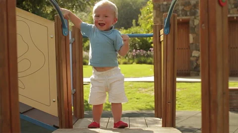 Young toddler walking on play structure. Stock Footage 43630839