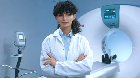 Young tomography specialist posing with crossed arms. Friendly doctor at Stock Footage 267092203