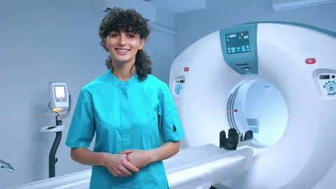 Young tomography specialist posing with wide smile. Cheerful doctor smiling at Stock Footage 267093288